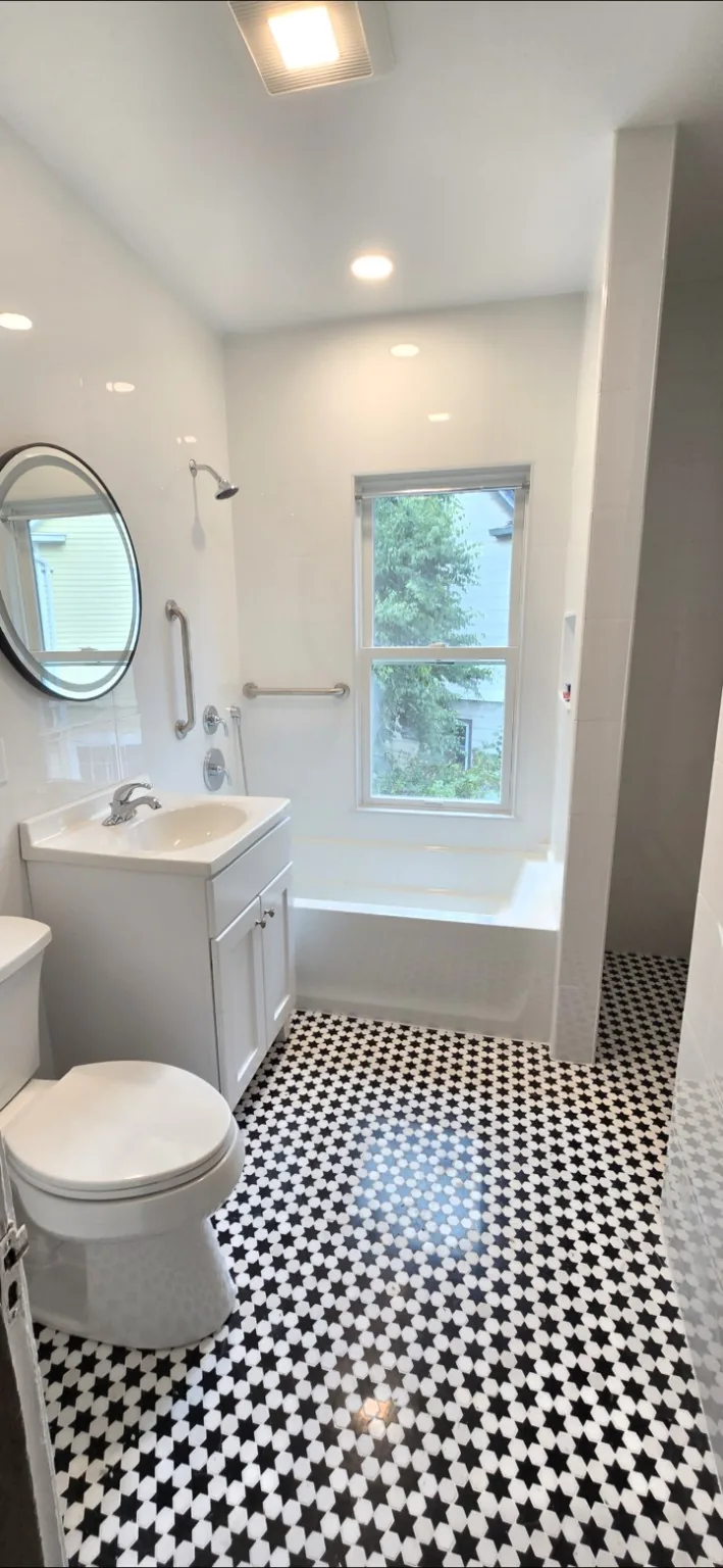White bathroom with black star patterned tile floor