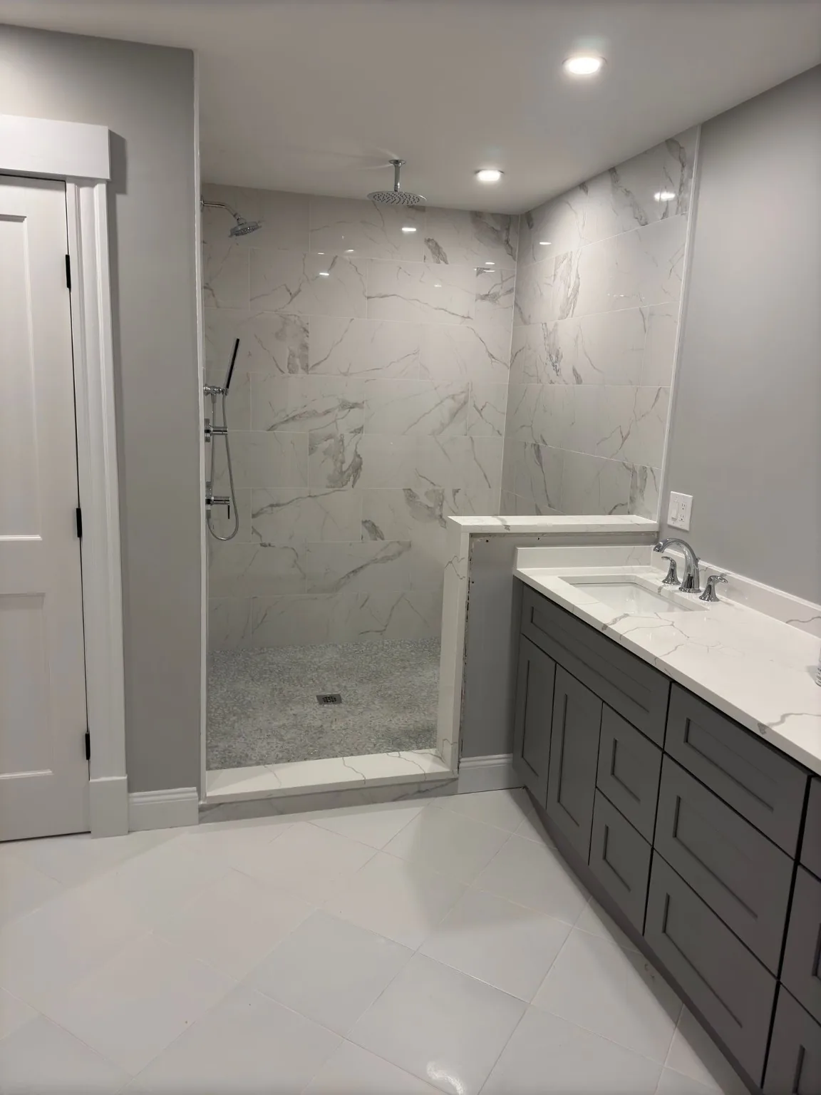 Finished walk-in shower and double vanity bathroom remodel by America Trust Builders