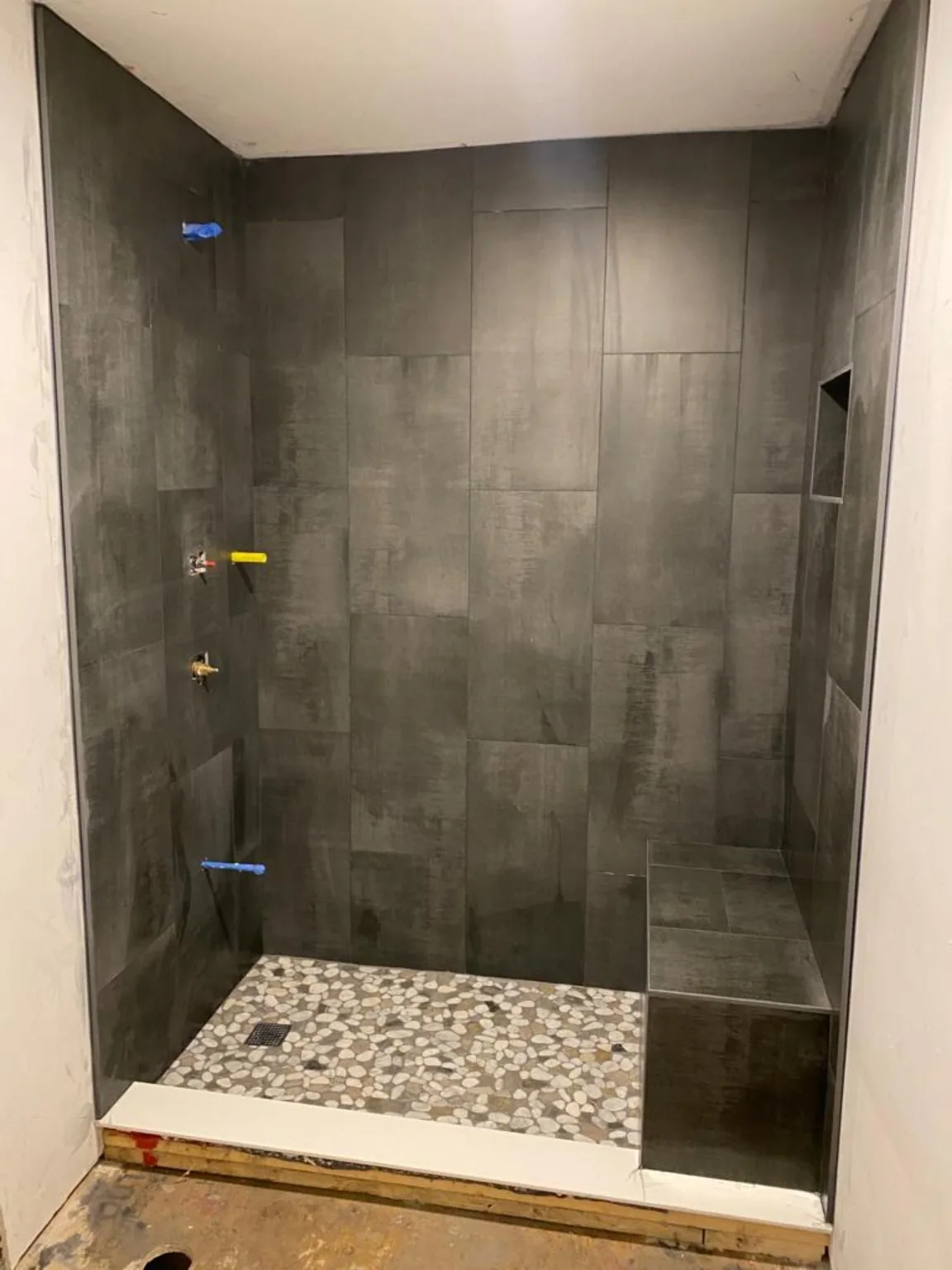 Walk-in shower tile installation in progress